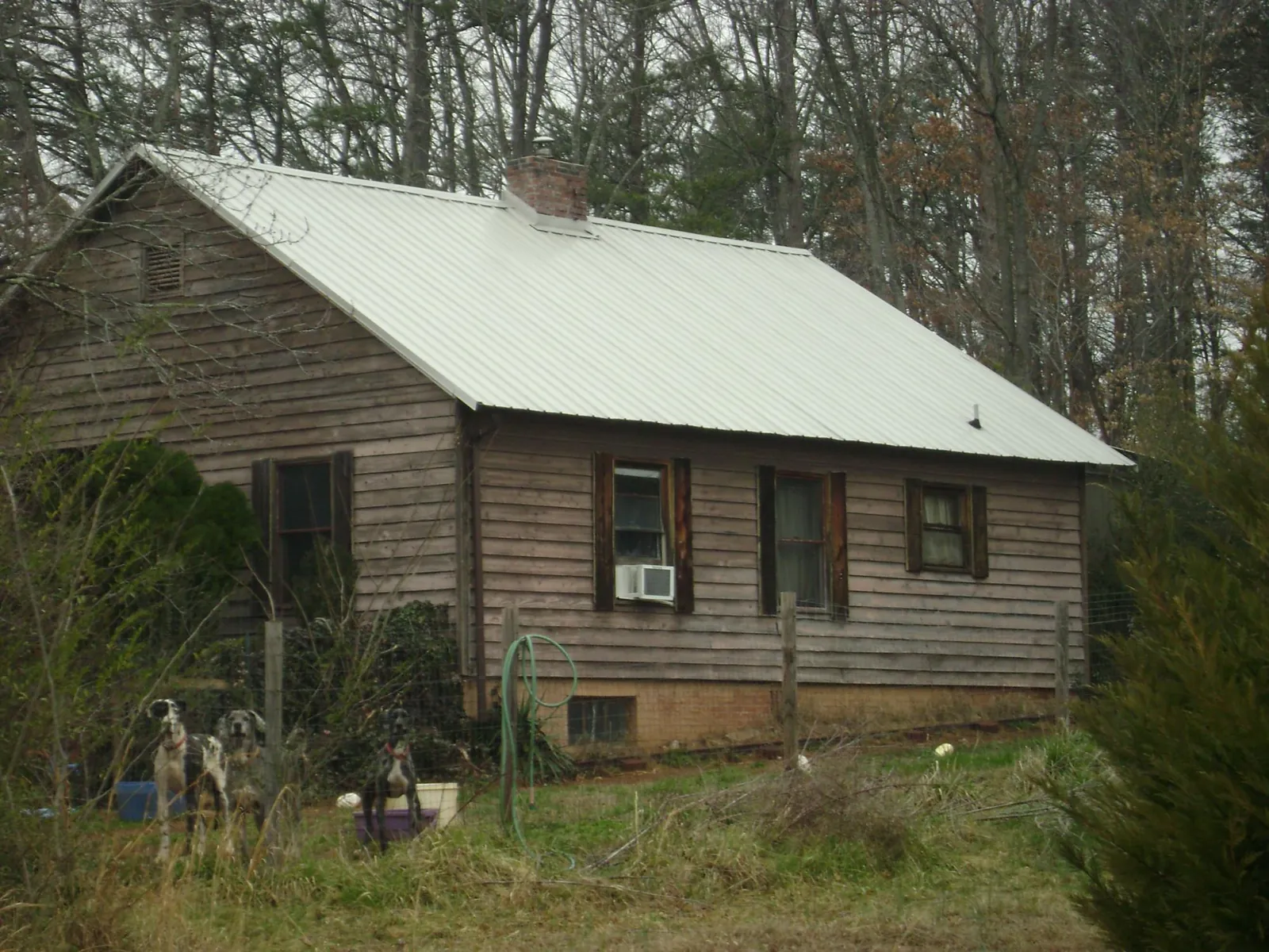White metal roof on an old wood sided farmhouse, from a Metal Roof Installation job in O Fallon
